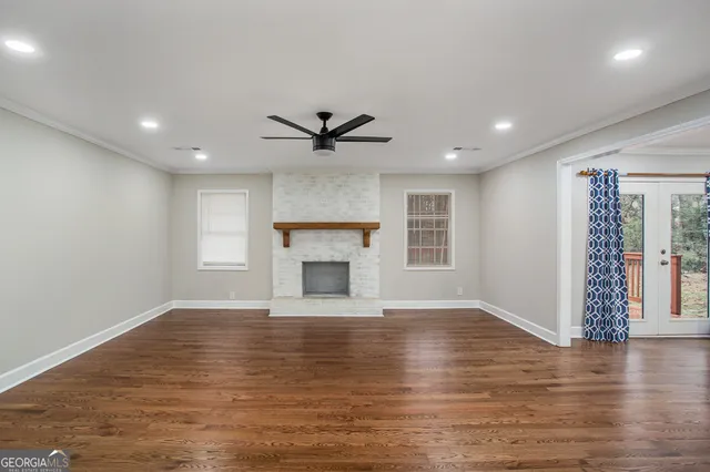 a view of an empty room with kitchen appliances and a window