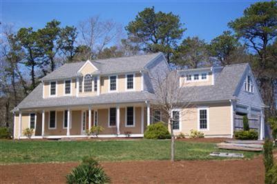 711 Great Neck Road South Mashpee, MA 02649 - Photo 1 of 6 front view of a brick house with a yard