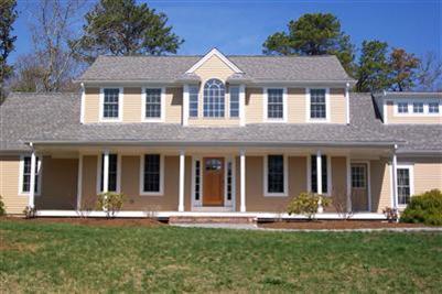 711 Great Neck Road South Mashpee, MA 02649 - Photo 2 of 6 front view of brick house with a yard