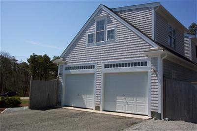 711 Great Neck Road South Mashpee, MA 02649 - Photo 3 of 6 a front view of a house with a garage
