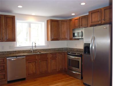 711 Great Neck Road South Mashpee, MA 02649 - Photo 6 of 6 a kitchen with kitchen island granite countertop stainless steel appliances and wooden cabinets