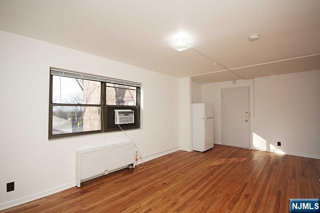 3020 Edwin Avenue, Unit 2J Fort Lee, NJ 07024 - Photo 5 of 8 a view of empty room with wooden floor and fan