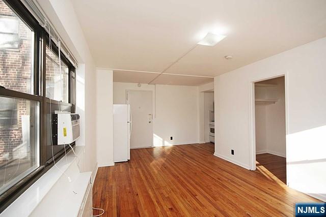 3020 Edwin Avenue, Unit 2J Fort Lee, NJ 07024 - Photo 6 of 8 a bedroom with a bed and a large window