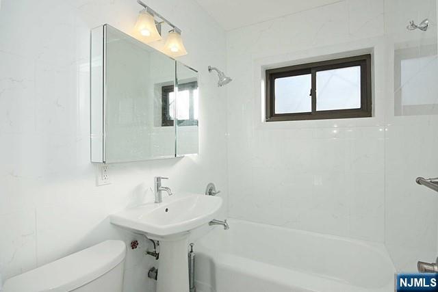 3020 Edwin Avenue, Unit 2J Fort Lee, NJ 07024 - Photo 8 of 8 a bathroom with a sink a toilet and shower