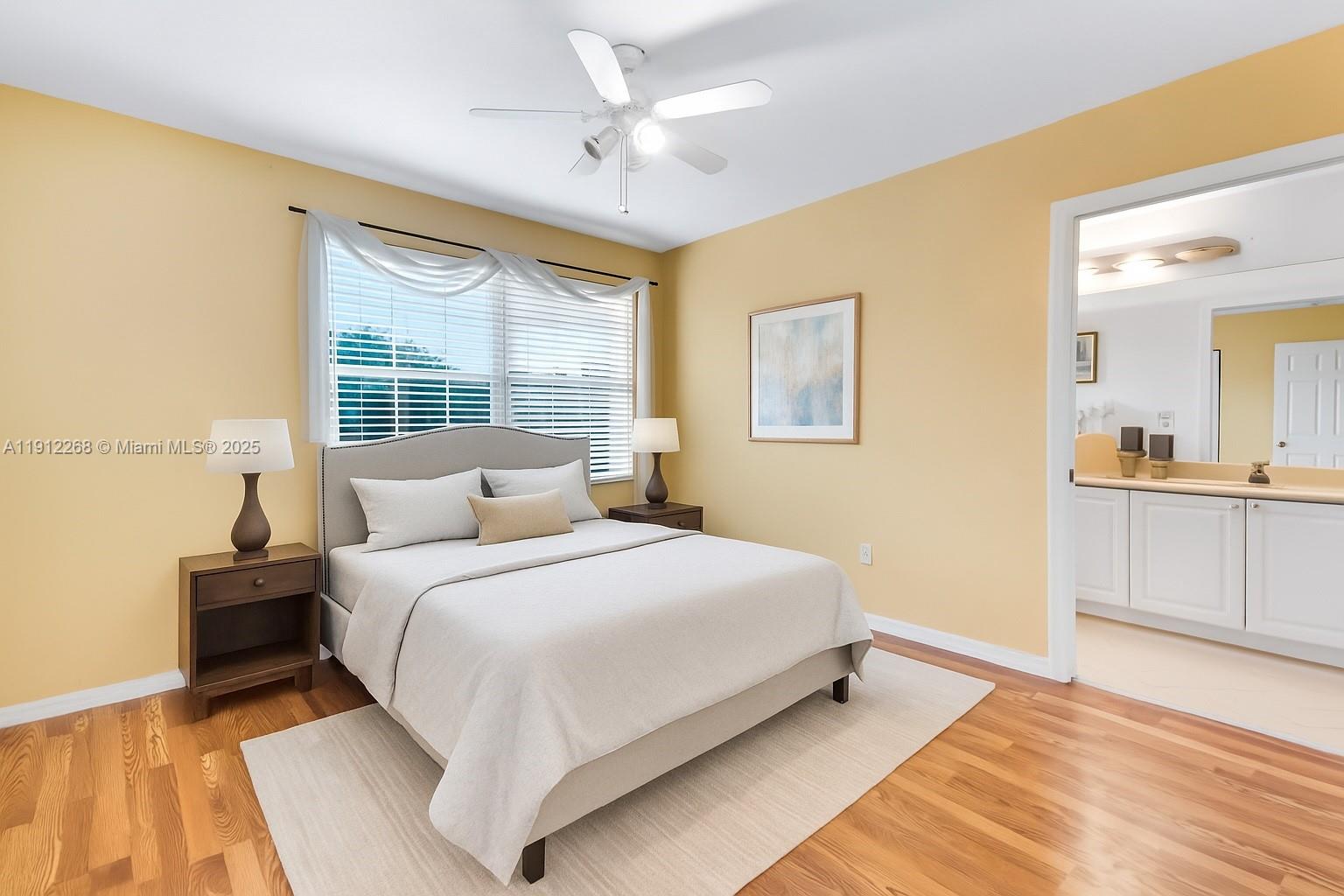 16285 Southwest 19th Street Miramar, FL 33027 - Photo 11 of 36 a bedroom with a large bed and a chandelier