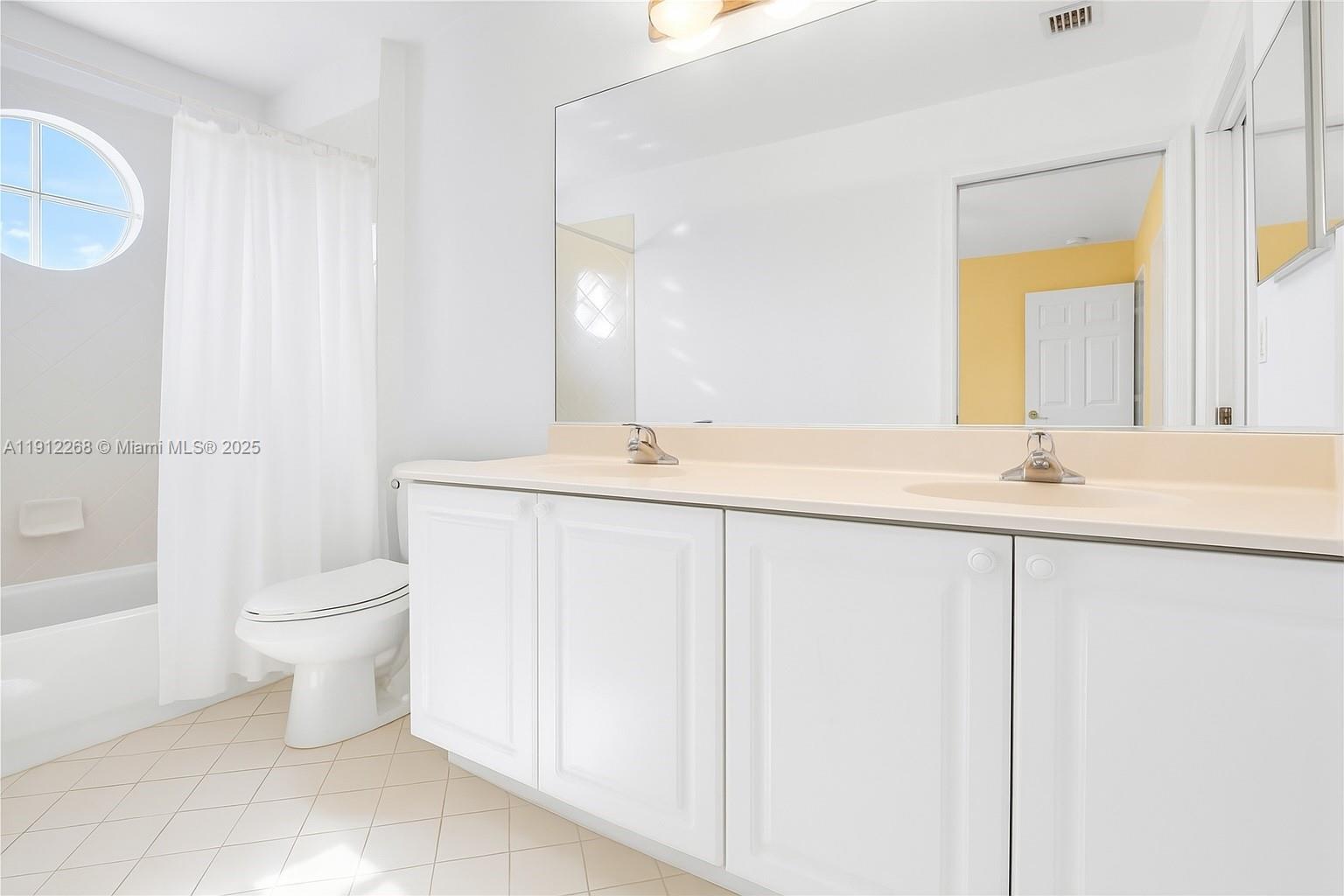 16285 Southwest 19th Street Miramar, FL 33027 - Photo 12 of 36 a bathroom with a granite countertop sink a toilet and a mirror