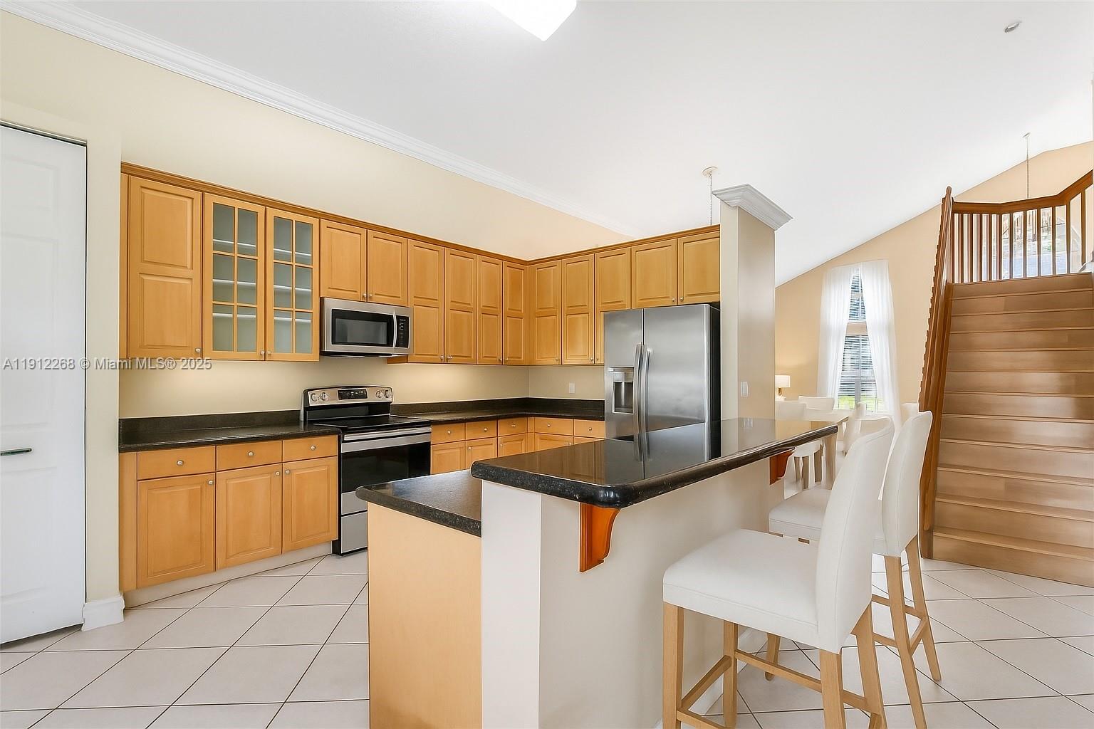 16285 Southwest 19th Street Miramar, FL 33027 - Photo 2 of 36 a kitchen with stainless steel appliances granite countertop a sink and cabinets