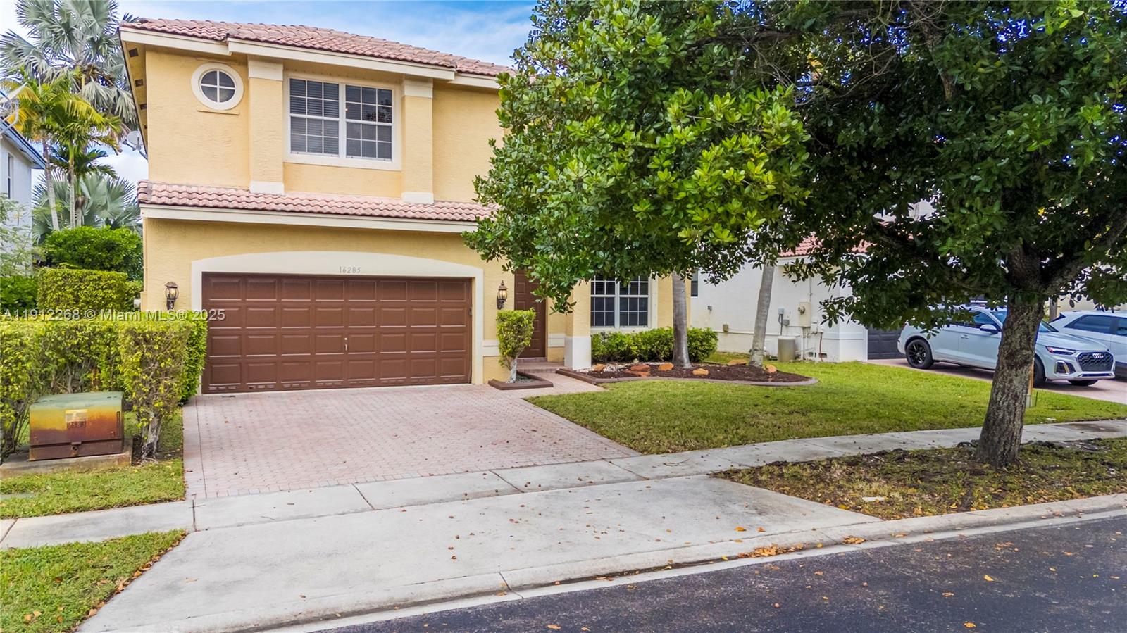 16285 Southwest 19th Street Miramar, FL 33027 - Photo 32 of 36 a front view of a house with a yard and a garage