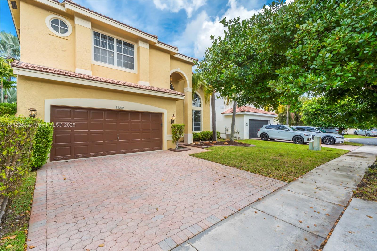 16285 Southwest 19th Street Miramar, FL 33027 - Photo 33 of 36 a front view of a house with a yard and garage