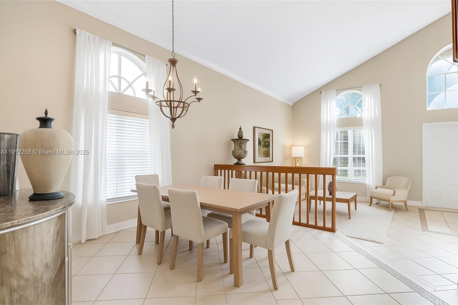 16285 Southwest 19th Street Miramar, FL 33027 - Photo 6 of 36 a view of a dining room with furniture and a chandelier