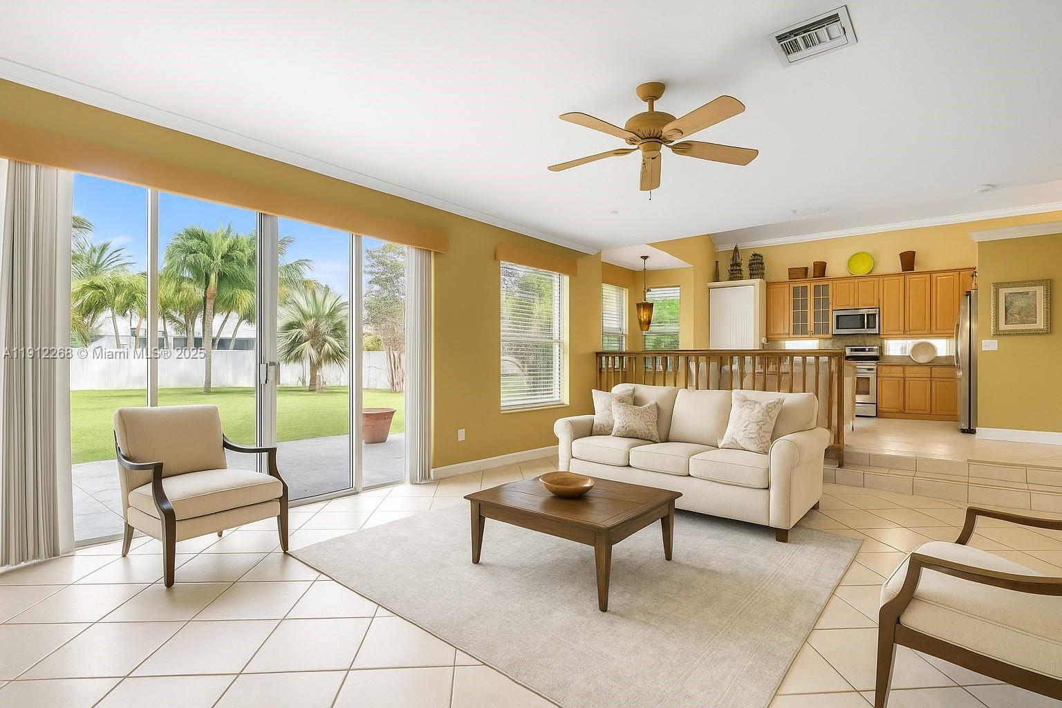 16285 Southwest 19th Street Miramar, FL 33027 - Photo 8 of 36 a living room with furniture and a floor to ceiling window
