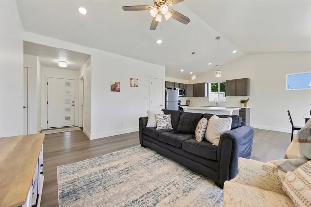 a living room with furniture and a chandelier