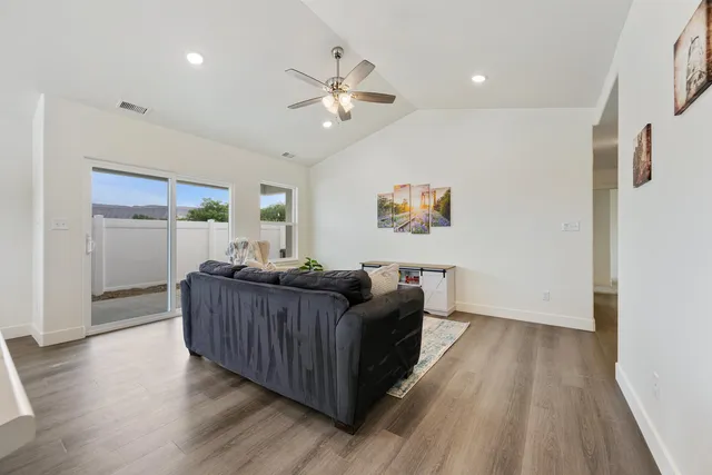 a living room with furniture and a wooden floor