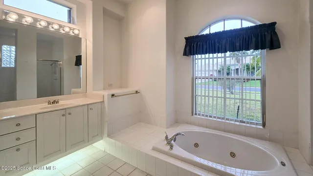 a bathroom with a bathtub a mirror a sinks and a shower