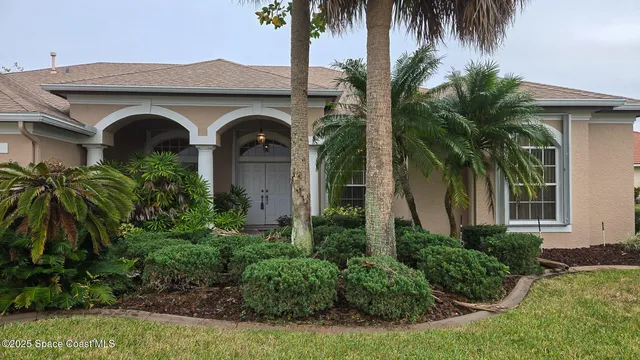 a front view of a house with a garden
