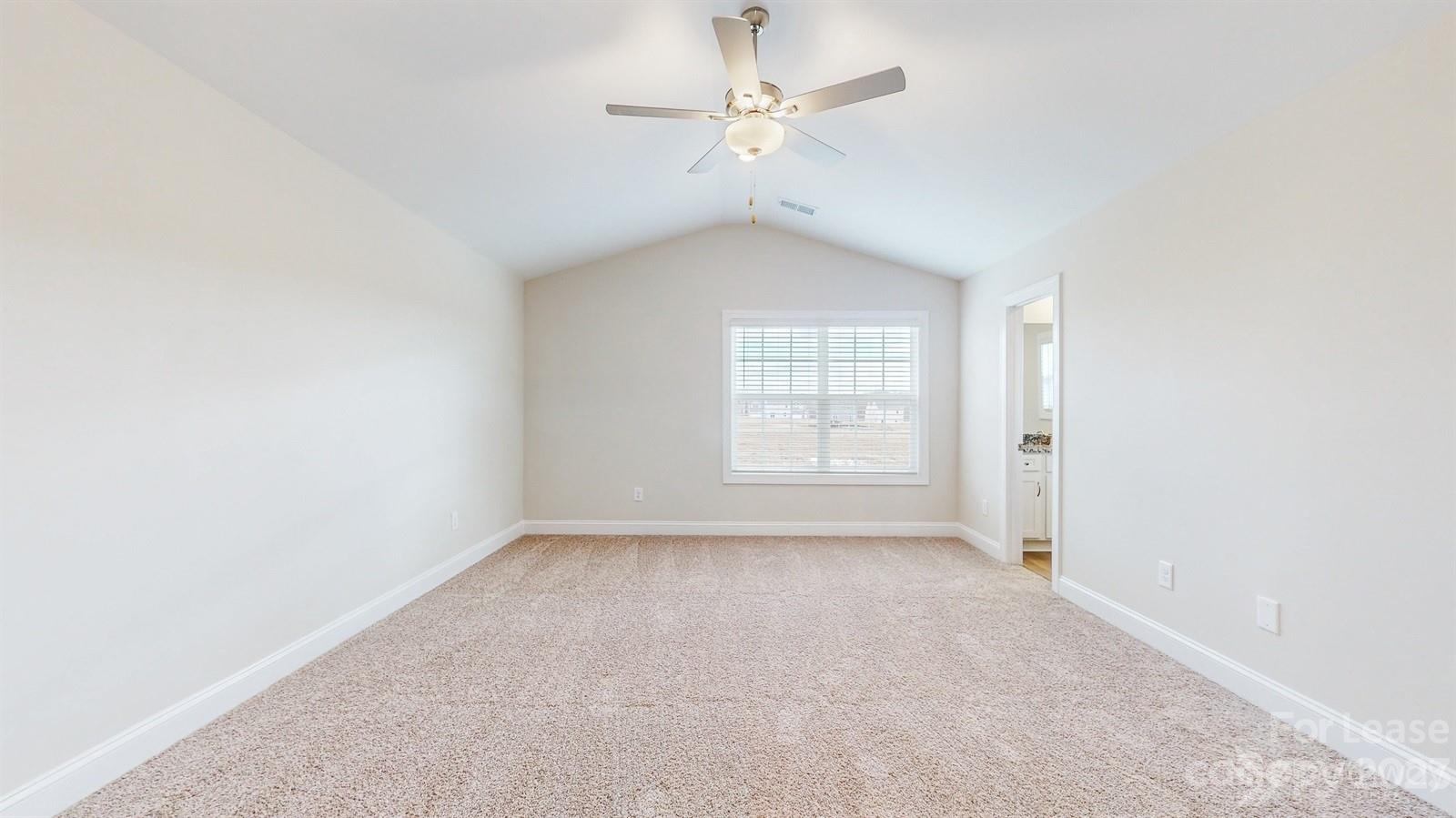 163 Brixham Loop Troutman, NC 28166 - Photo 13 of 34 an empty room with windows and ceiling fan