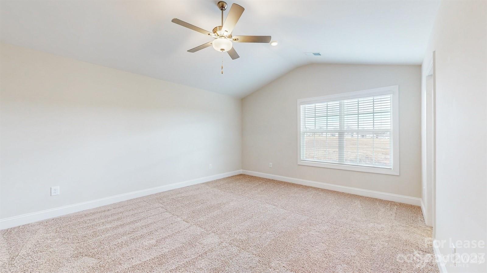 163 Brixham Loop Troutman, NC 28166 - Photo 15 of 34 an empty room with a window and a ceiling fan