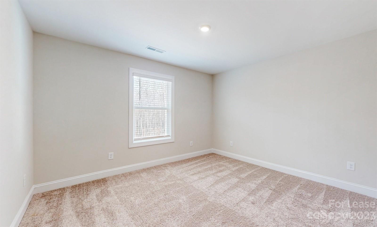 163 Brixham Loop Troutman, NC 28166 - Photo 19 of 34 an empty room with a window