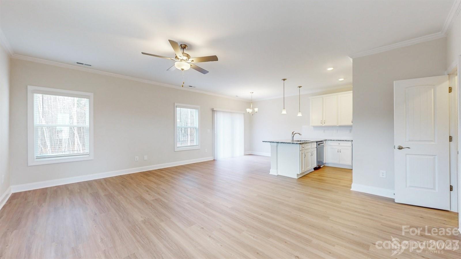 163 Brixham Loop Troutman, NC 28166 - Photo 2 of 34 a view of an empty room with window and wooden floor