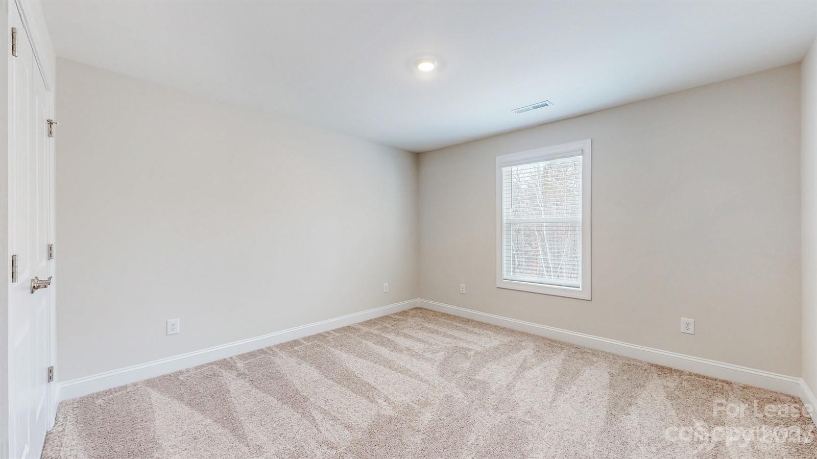 163 Brixham Loop Troutman, NC 28166 - Photo 21 of 34 an empty room with a window