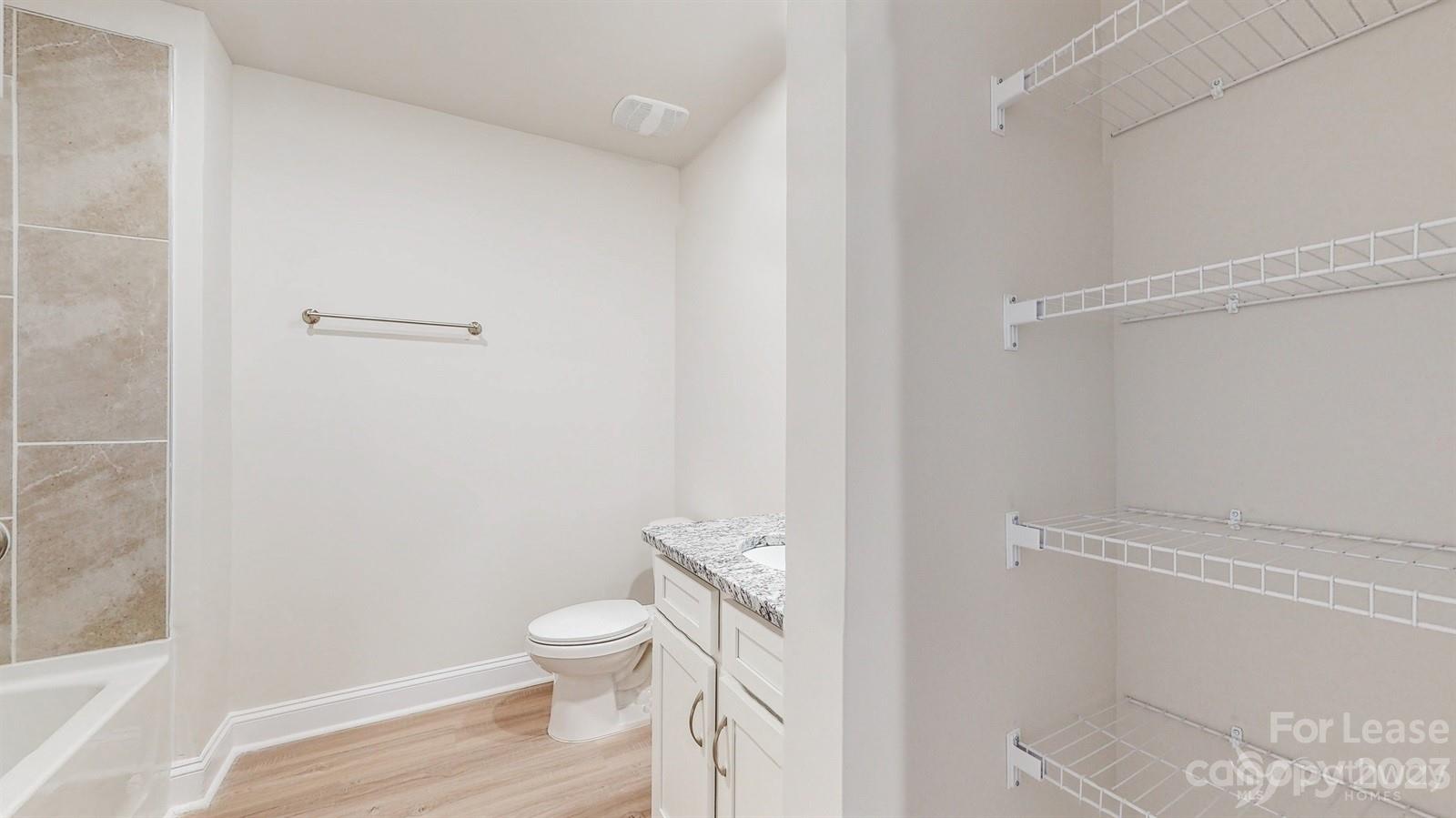 163 Brixham Loop Troutman, NC 28166 - Photo 23 of 34 a bathroom with a granite countertop toilet and a shower