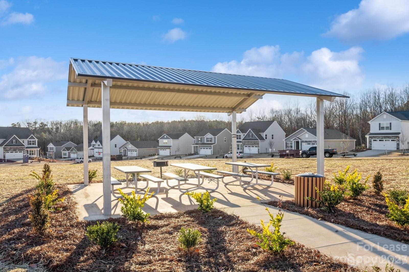163 Brixham Loop Troutman, NC 28166 - Photo 30 of 34 a view of a swimming pool with a lawn chairs under an umbrella