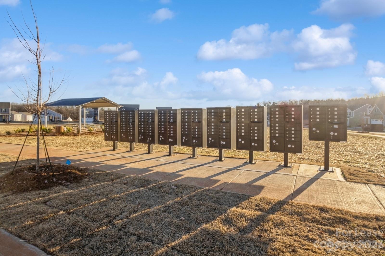 163 Brixham Loop Troutman, NC 28166 - Photo 31 of 34 a building with trees in front of it