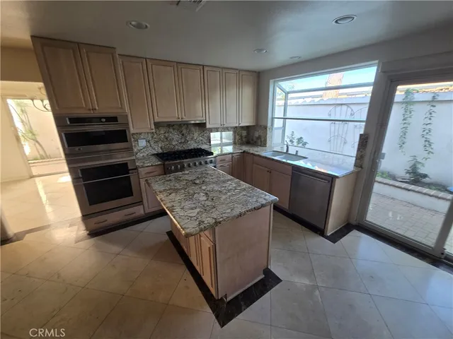 a kitchen with a stove and a refrigerator