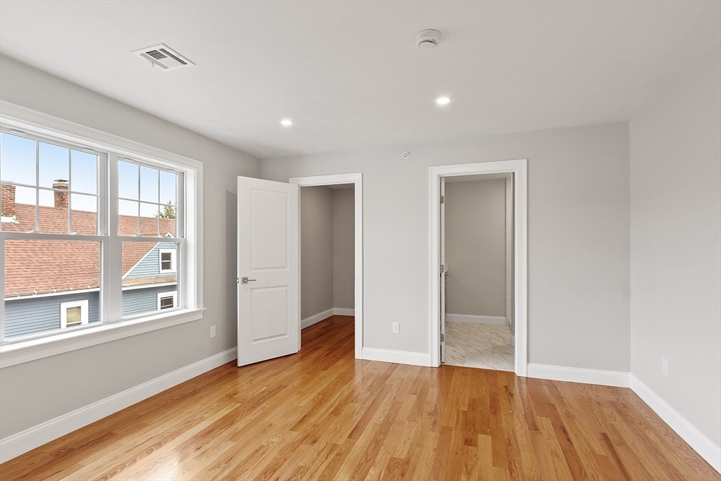 10 Windsor Street Worcester, MA 01605 - Photo 13 of 26 a view of an empty room with wooden floor and a window