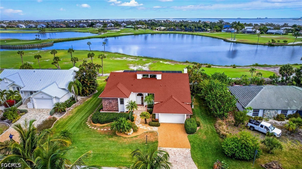 1057 Sand Castle Road Sanibel, FL 33957 - Photo 1 of 50 an aerial view of a house with a garden and lake view