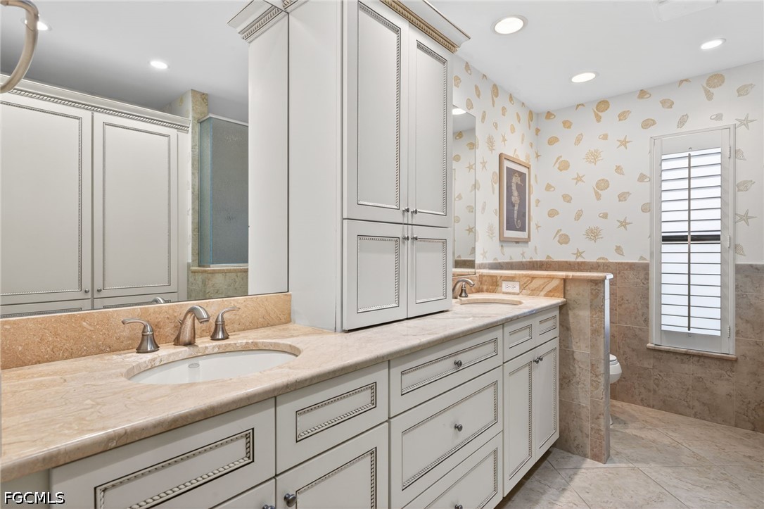 1057 Sand Castle Road Sanibel, FL 33957 - Photo 28 of 50 a bathroom with a granite countertop sink mirror and double