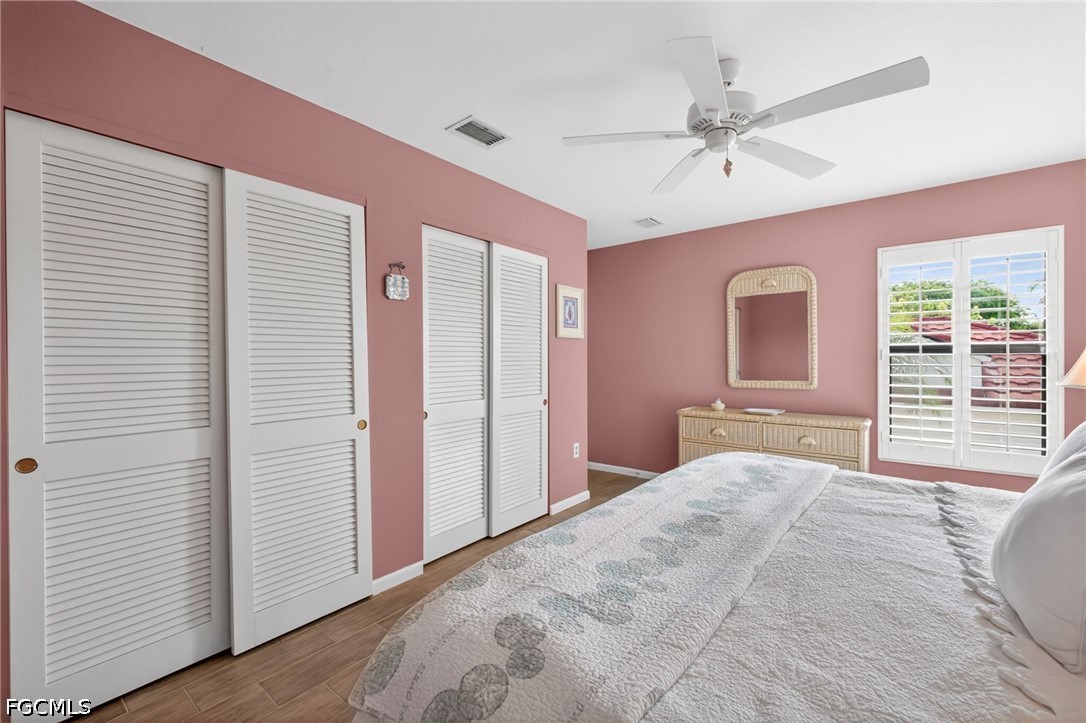1057 Sand Castle Road Sanibel, FL 33957 - Photo 31 of 50 a bedroom with a large bed and a chandelier