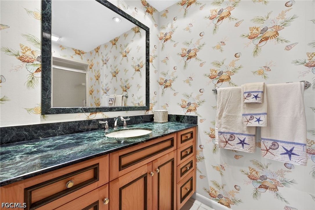 1057 Sand Castle Road Sanibel, FL 33957 - Photo 32 of 50 a bathroom with a granite countertop sink and a mirror