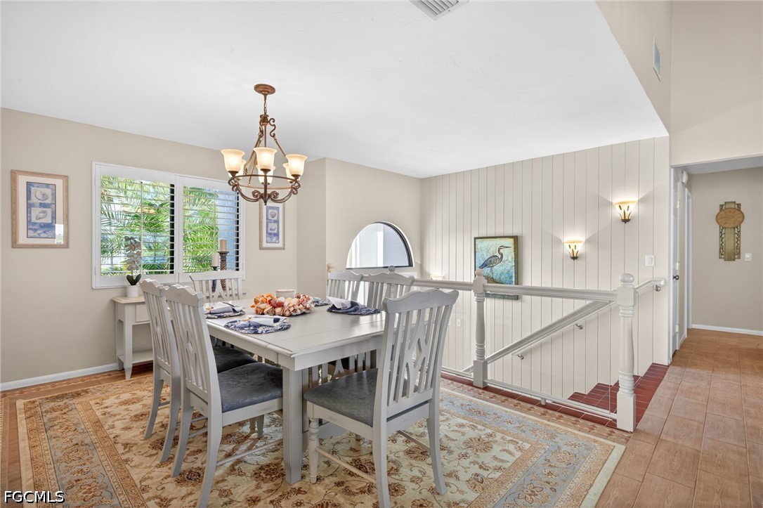 1057 Sand Castle Road Sanibel, FL 33957 - Photo 6 of 50 a dining room with furniture a chandelier and window