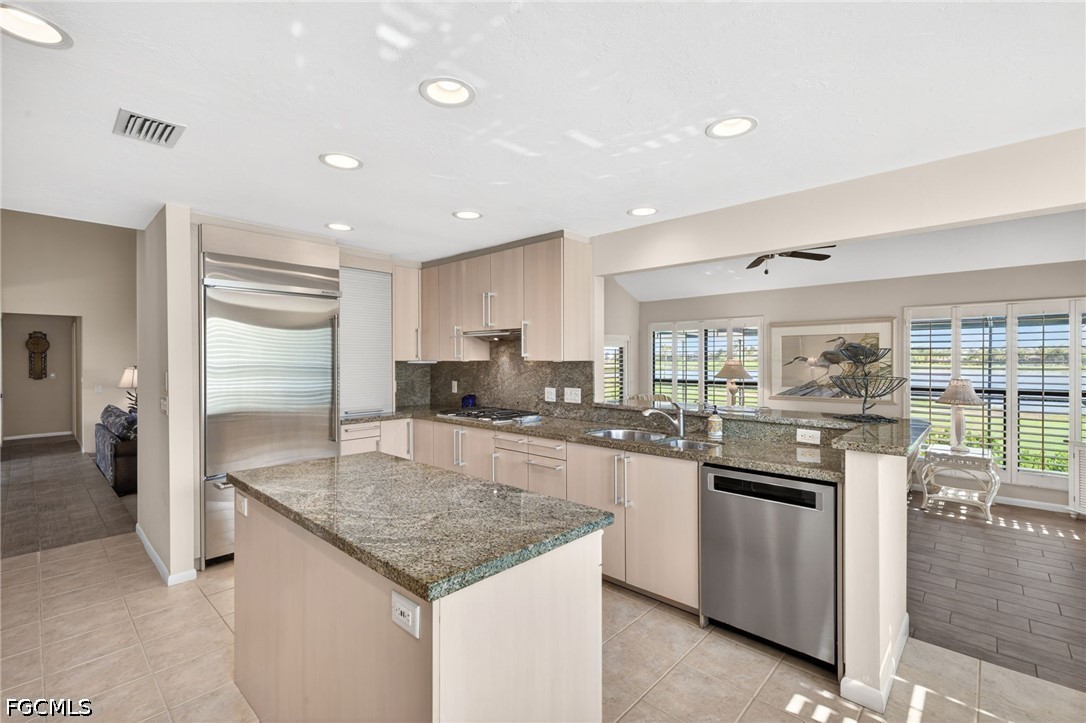1057 Sand Castle Road Sanibel, FL 33957 - Photo 8 of 50 a kitchen with stainless steel appliances granite countertop a sink stove and refrigerator