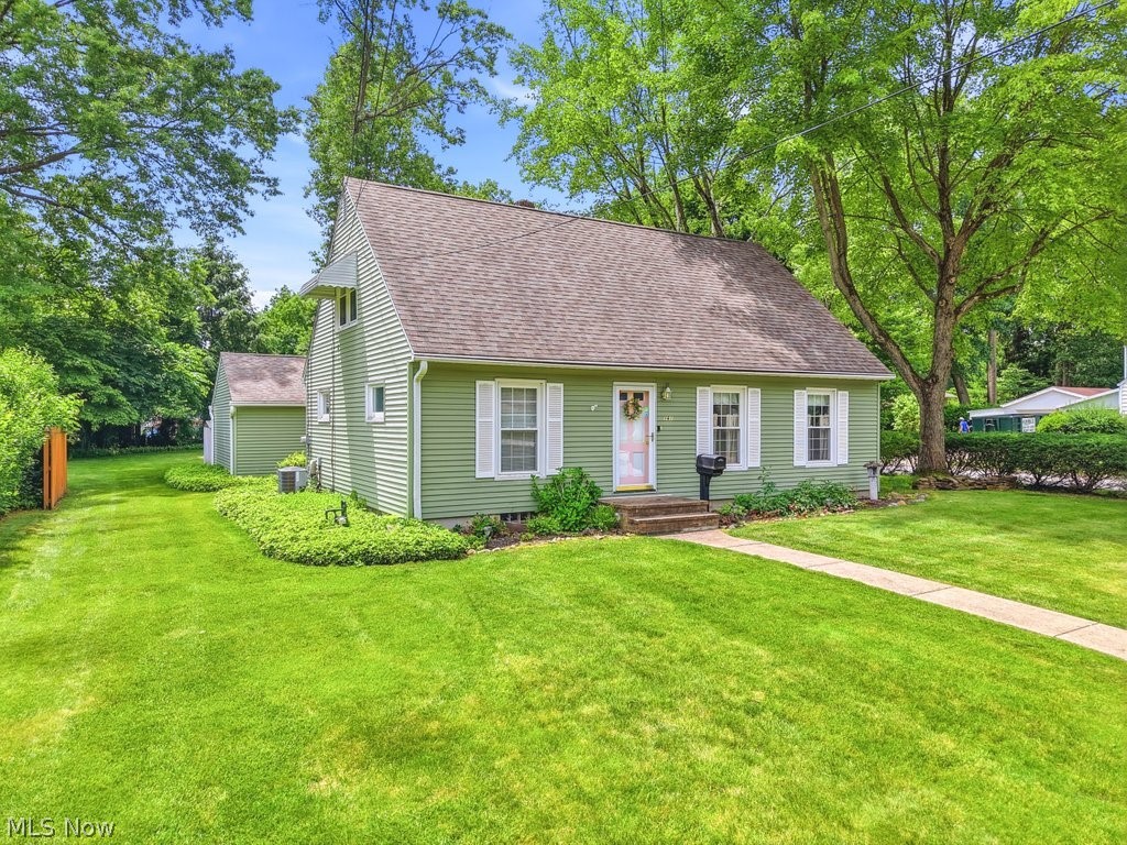 161 Pinehurst Road Munroe Falls, OH 44262 - Photo 2 of 40 Light green siding residence with white window shutters and a brown shingle roof
