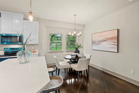 a dining room with furniture a window and wooden floor