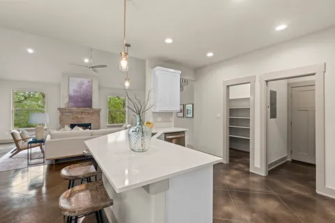 a kitchen with a table chairs refrigerator and cabinets