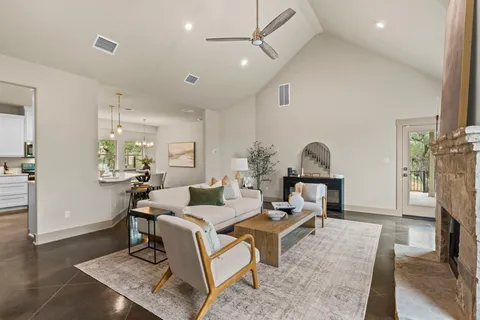a living room with furniture and a wooden floor