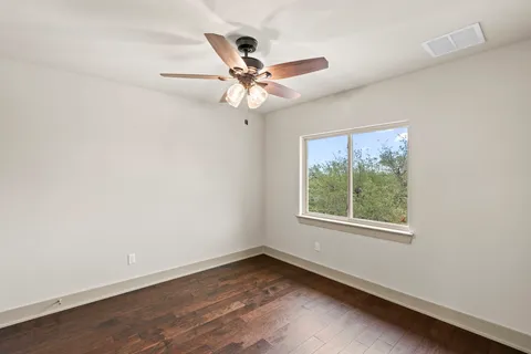 a view of an empty room with a fan