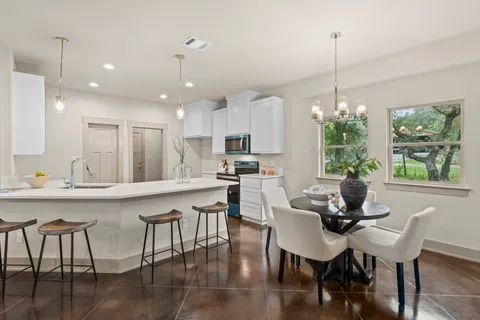 a dining room with furniture a window and wooden floor