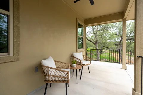 a view of a chair and table in the balcony