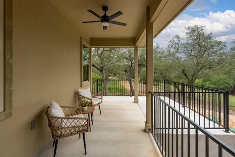 a view of a porch with furniture and a yard