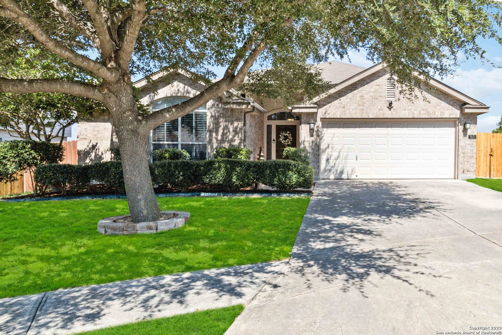 a front view of house with a garden