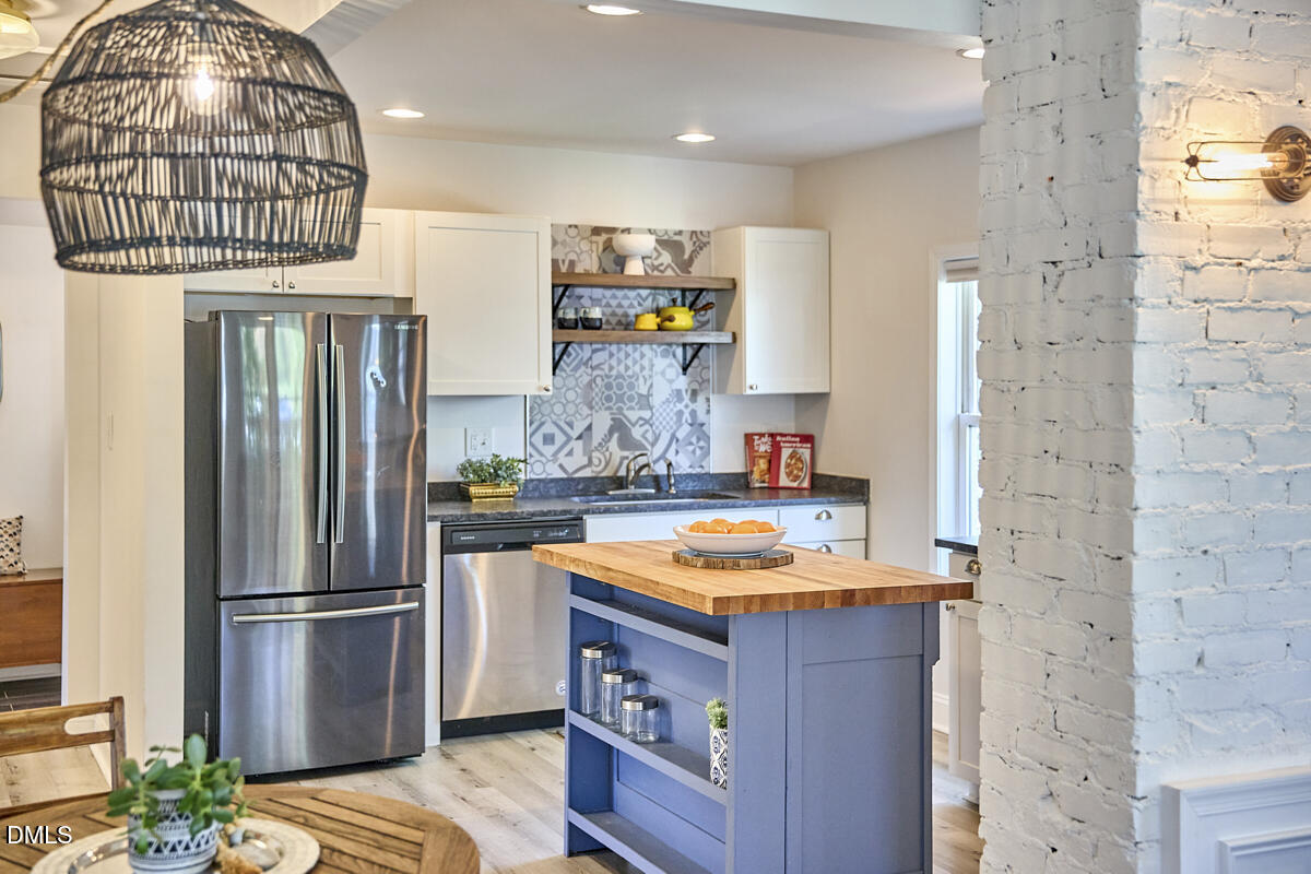 214 Moline Street Durham, NC 27707 - Photo 14 of 49 a kitchen with stainless steel appliances granite countertop a refrigerator and a stove