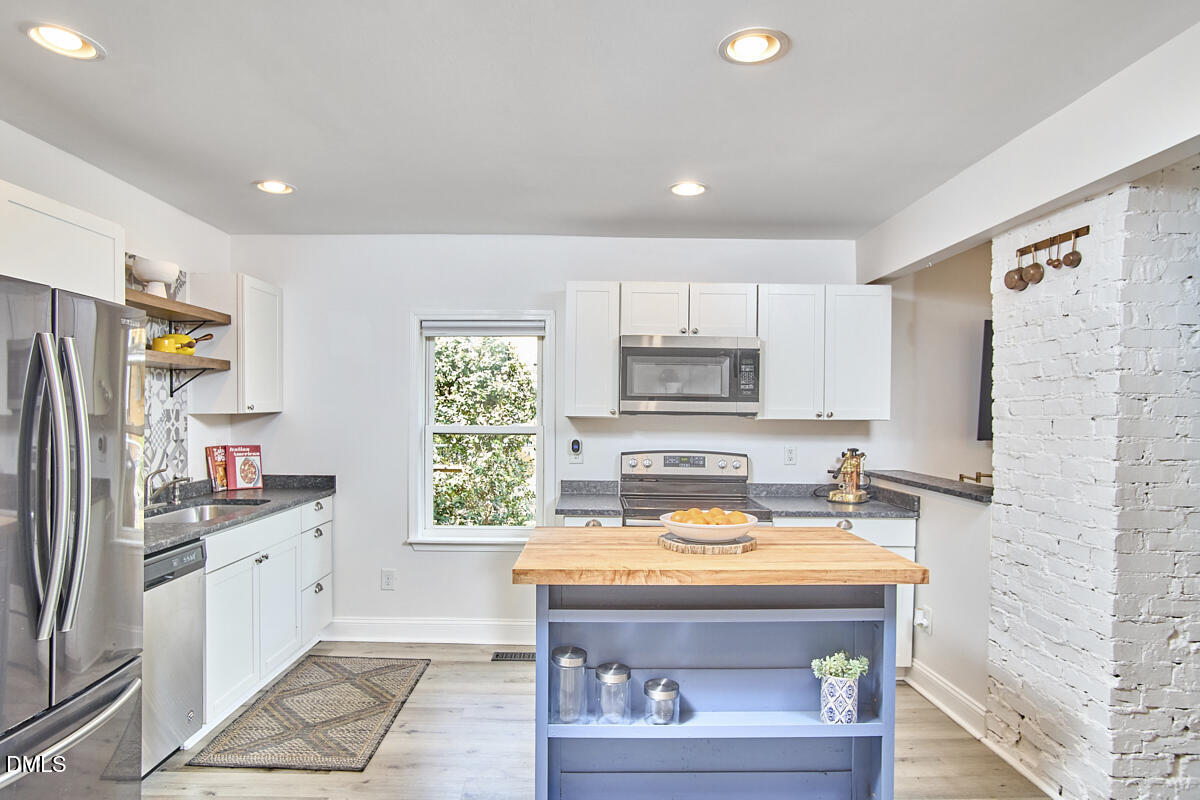 214 Moline Street Durham, NC 27707 - Photo 15 of 49 a kitchen with a sink cabinets and window