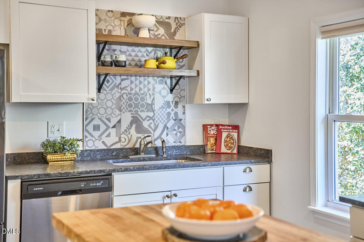 214 Moline Street Durham, NC 27707 - Photo 20 of 49 a kitchen with stainless steel appliances granite countertop a stove and cabinets