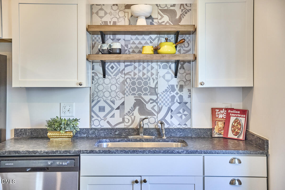 214 Moline Street Durham, NC 27707 - Photo 21 of 49 a kitchen with stainless steel appliances granite countertop a sink and cabinets
