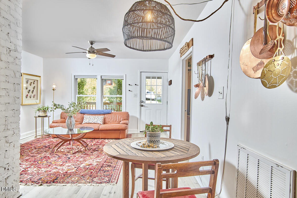 214 Moline Street Durham, NC 27707 - Photo 24 of 49 a living room with furniture chandelier and a table