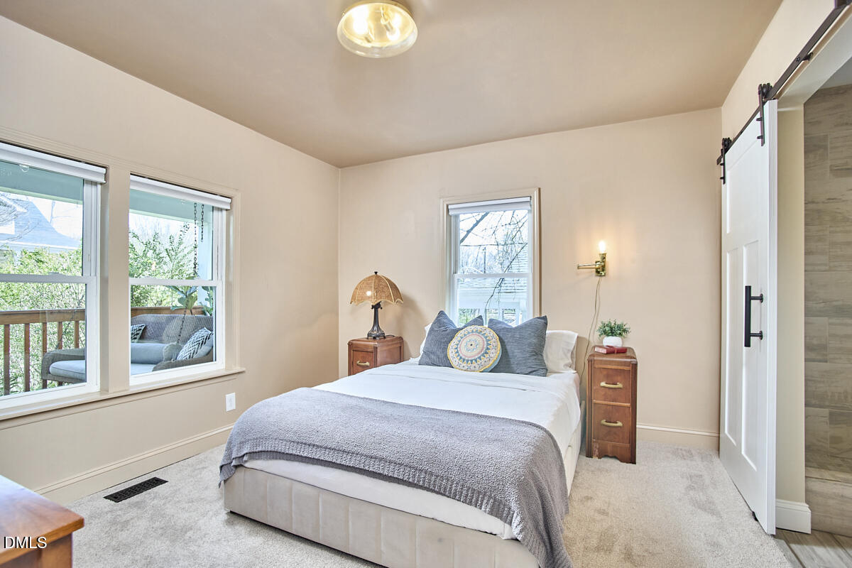 214 Moline Street Durham, NC 27707 - Photo 26 of 49 a bedroom with a bed and a large window